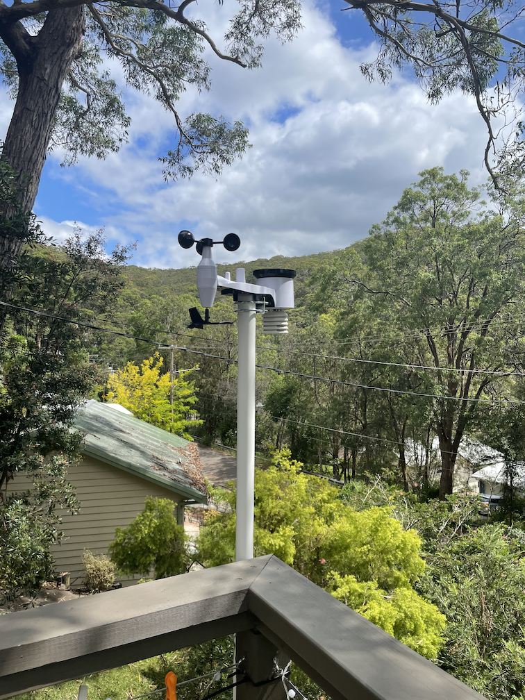 photo of the weather station mounted on the edge of a deck